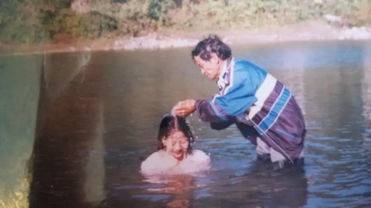 Rev. Dana Pertin giving baptism